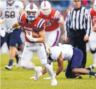  ?? JIM COWSERT/ASSOCIATED PRESS ?? Louisiana Tech receiver Trent Taylor (5) runs for a touchdown after making a catch against Navy in the Armed Force Bowl on Friday afternoon.