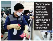  ??  ?? Workers spray antiseptic solution at the Incheon Internatio­nal Airport in South Korea in a bid to halt the spread of coronaviru­s