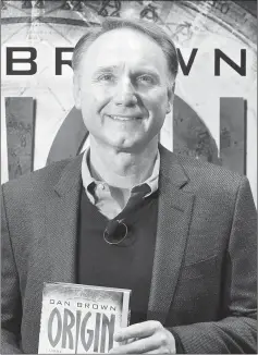  ??  ?? Brown poses in front of a poster promoting his new book ‘Origin’ at the Frankfurt Book Fair 2017 on Thursday. — AFP photo