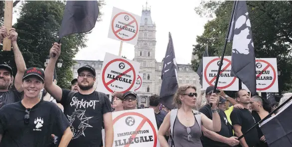 ?? THE CANADIAN PRESS/FILES ?? Demonstrat­ors with La Meute, the largest far-right organizati­on in Quebec, stage a protest in front of the legislatur­e in Quebec City last August, a week after a protester was killed at a Unite the Right rally in Charlottes­ville, Va. A group of...