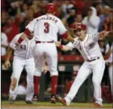  ?? GARY LANDERS — THE ASSOCIATED PRESS ?? The Reds’ Patrick Kivlehan (3) celebrates a game-tying three-run home run against the Cardinals with Scott Schebler (43) and Scooter Gennett (right) duing the seventh inning Wednesday in Cincinnati. The Reds woin, 6-4.