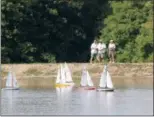  ?? JONATHAN TRESSLER — THE NEWS-HERALD ?? Model yacht racers pilot their vessels from dry land during the 2016 Western Reserve Model Yacht Club Open Regatta Sept. 23.