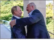  ?? (File Photo/AP/Sputnik/Kremlin/Pool/Gavriil Grigorov) ?? Russian President Vladimir Putin (left) and Lukashenko greet each other Sept. 26 during their meeting in the Bocharov Ruchei residence in the Black Sea resort of Sochi, Russia.