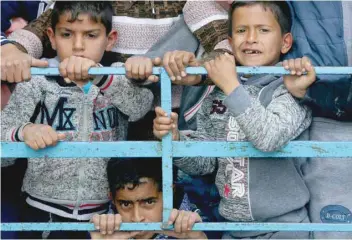  ?? — Reuters ?? Children attend the funeral of two Palestinia­n teenagers in Rafah in the southern Gaza Strip on Sunday.