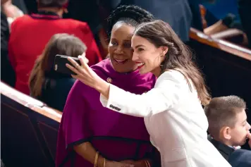  ?? (Erin Schaff/The New York Times) ?? Incoming Reps. Alexandria Ocasio-Cortez, right, and Sheila Jackson Lee take a selfie before being sworn into Congress at the Capitol in Washington, on Jan. 3, 2019.