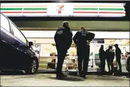  ?? Chris Carlson / Associated Press ?? U.S. Immigratio­n and Customs Enforcemen­t agents serve an employment audit notice at a 7-Eleven convenienc­e store in Los Angeles.