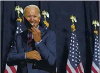  ?? CAROLYN KASTER — THE ASSOCIATED PRESS ?? Democratic presidenti­al candidate Joe Biden smiles as he puts on his mask after speaking to media in Wilmington, Del., on Friday.