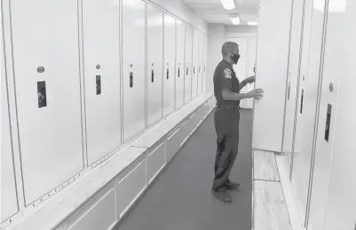  ?? BRAD HORRIGAN/HARTFORD COURANT ?? Chief of Police Donald Melanson gives a tour of the men’s locker room in the new Windsor police station.