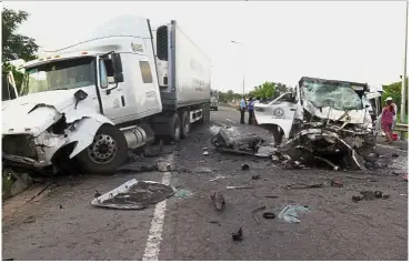  ?? — AFP ?? Tragic end: Debris is strewn on the road after a van heading to a wedding party collided with a truck in the early hours of the morning in Quang Nam province.