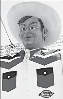  ?? AP Photo/The Dallas Morning News, Sarah Hoffman ?? Big Tex, the 55-foot-tall symbol of the State Fair of Texas, is unveiled Thursday, one day earlier than scheduled, in Dallas.