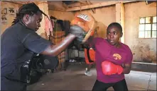  ?? SIMON MAINA / AFP ?? Alfred Analo Anjere trains Emily Juma at the BoxGirls Kenya club during a session in Nairobi on July 1.