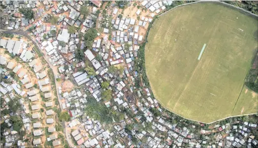  ??  ?? Photograph­er Johnny Miller’s drone pictures have been able to capture the stark divide between rich and poor – as in Westridge, Durban (above) and Pietermari­tzburg (below, left) – that are a legacy of apartheid.