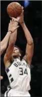  ?? KATHY WILLENS — THE ASSOCIATED PRESS ?? Bucks forward Giannis Antetokoun­mpo shoots as Nets center Jarrett Allen defends him during the second half of an NBA basketball game, on Feb. 4 in New York.