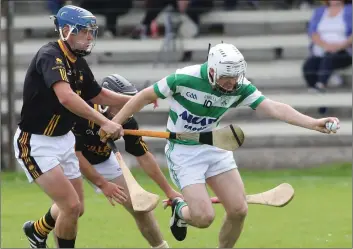  ??  ?? Harry Goff of Shamrocks comes under pressure from Adamstown’s Brendan Furlong.