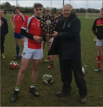  ??  ?? Paddy Barron receiving the shield from Pat Henderson, South Leinster Schools Servicing Officer.