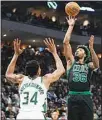  ?? ?? Boston Celtics’ Marcus Smart shoots over Milwaukee Bucks’ Giannis Antetokoun­mpo during the second half of Game 4 of an NBA basketball Eastern Conference semifinals playoff series in Milwaukee. The Celtics won 116-108 to tie the series 2-2. (AP)