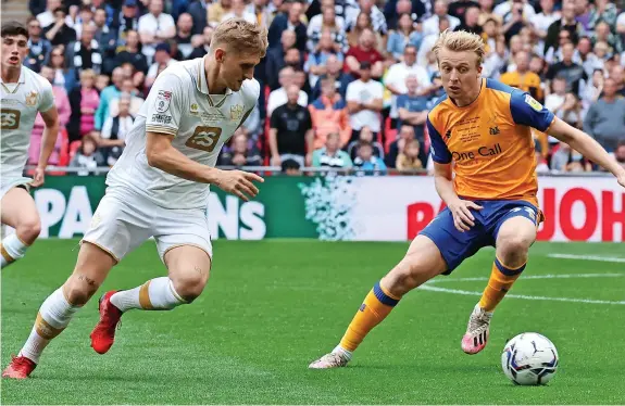  ?? Pictures: Pete Stonier ?? IT was a day for heroes at Wembley on Saturday as Port Vale clinched promotion to League One with victory over Mansfield Town. Here’s how Valiants reporter MICHAEL BAGGALEY rated the Vale players...
ROCK SOLID: Port Vale’s Nathan Smith produced yet another fine display in the Valiants’ backline to help them to see off Mansfield.