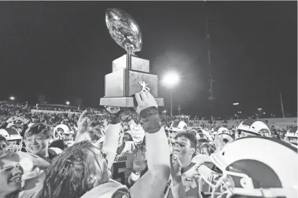  ?? ALONZO J. ADAMS/SPECIAL TO THE OKLAHOMAN ?? Owasso celebrates with the championsh­ip trophy after defeating Jenks in the OSSAA 6A-1 championsh­ip game in Edmond on Dec. 7, 2019.