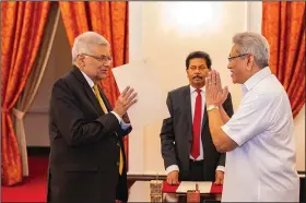  ?? ?? President Gotabaya Rajapaksa (right) greets Ranil Wickremesi­nghe during the latter’s oath taking ceremony as the new prime minister Thursday in Colombo, Sri Lanka. (AP/Sri Lankan President’s Office)