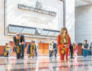  ??  ?? House speaker Nancy Pelosi and other members of Congress kneel in memory of George Floyd.