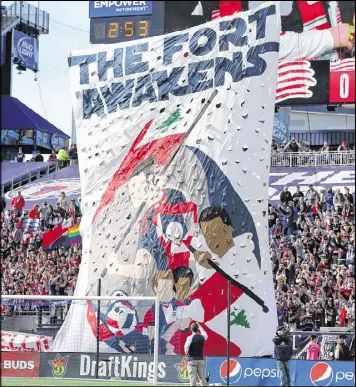  ?? MADDIE MEYER / GETTY IMAGES ?? New England Revolution fans raise a banner to show support for their team before games at Gillette Stadium in Foxborough, Mass.