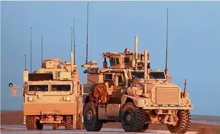  ?? — AFP ?? Numbered days: US Marine Corps personnel driving tactical vehicles along a road near the town of Tal Baydar in Syria’s northeaste­rn Hasakeh province.