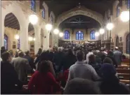  ?? EVAN BRANDT — MEDIANEWS GROUP ?? Everyone joined hands to sing “We Shall Overcome” as the service ended Sunday.