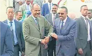  ?? AP ?? Ethiopia’s Prime Minister Abiy Ahmed, centre right, is welcomed by Eritrea’s President Isaias Afwerki as he disembarks on a visit to Eritrea earlier this week.