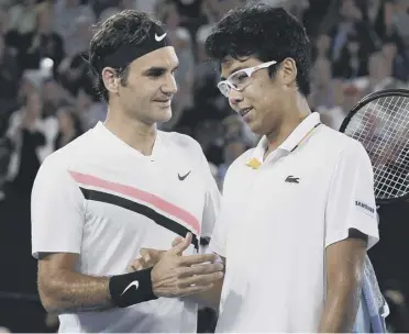  ??  ?? Roger Federer and Hyeon Chung shake hands after the South Korean retired from their semi-final.