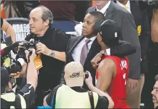  ?? THE CANADIAN PRESS/TONY AVELAR ?? Toronto Raptors general manager Masai Ujiri, centre left, walks with guard Kyle Lowry following an altercatio­n after the Raptors defeated the Golden State Warriors in the NBA Finals in Oakland, Calif., on June 13, 2019.