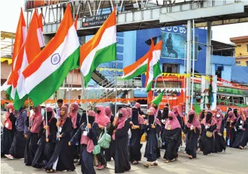  ?? — PTI ?? Women hold the national flag as they participat­e in ‘Samarasyad­a Nadige, Sahabalve Samavesha’, a rally organised for communal harmony in Udupi on Saturday.