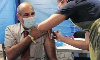  ?? | DOCTOR NGCOBO African News Agency (ANA) ?? CO-CHAIRPERSO­N of the Ministeria­l Advisory Committee on Covid-19 and director of Caprisa, Professor Salim Abdool Karim, gets the Johnson & Johnson vaccine against Covid-19 at Netcare St Augustine’s Hospital yesterday.