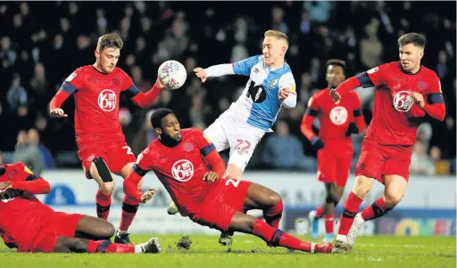  ?? Richard Sellers ?? Lewis Holtby is challenged by Wigan Athletic’s Chey Dunkley during Monday’s match at Ewod Park