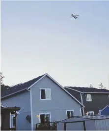  ?? COURTNEY JUNKA VIA AP, ABOVE; AP PHOTO, RIGHT ?? PERIL IN THE SKY: Photo taken from video shows the stolen Horizon Air plane flying over Eatonville, Wash., Friday before it crashed on a small island in Puget Sound, right.