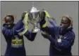  ?? CHARLES KRUPA — THE ASSOCIATED PRESS ?? Edna Kiplagat, left and Geoffrey Kirui, both of Kenya, hold a trophy together after their victories in the 121st Boston Marathon on Monday.