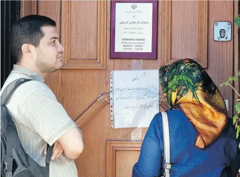  ?? WAYNE CUDDINGTON / POSTMEDIA NEWS FILES ?? People stand outside the Embassy of Iran in Ottawa in 2012 after then-foreign minister John Baird announced that diplomatic relations between Canada and Iran had been suspended.