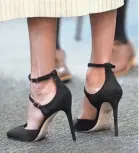  ?? YUI MOK/AFP/GETTY IMAGES ?? Meghan Markle’s heels are still high, but her hemlines have lowered considerab­ly.