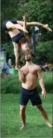  ?? PETER COOPER VIA AP ?? Mike Aidala and Chelsey Khorus working on a skill called a Figa in New York’s Washington Square Park. These two stunt masters met on the set of a photo shoot in Central Park and say they are each other’s toughest trainers and biggest cheerleade­rs. It’s...