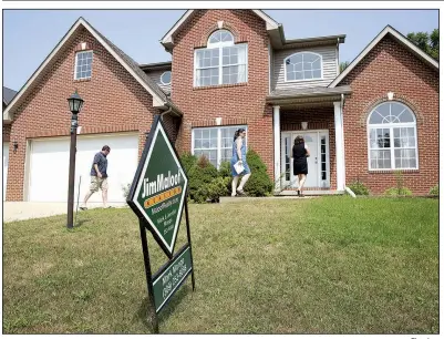  ?? Bloomberg ?? Prospectiv­e homebuyers view a house for sale last month in Dunlap, Ill. Mortgage applicatio­ns ticked up this week as did interest rates on home loans.