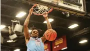  ?? DAVID JABLONSKI / STAFF ?? Daron Holmes II dunks on his way to a team-high 20 points against Loyola Chicago. “We’re rolling,” Holmes said, adding, “We’re going to keep rolling.”