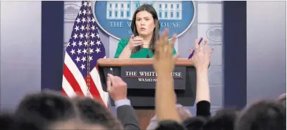  ?? Andrew Harnik ?? The Associated Press White House press secretary Sarah Sanders takes a question from a reporter during a press briefing Monday. Sanders also gave a statement on the shooting at a Pittsburgh synagogue.