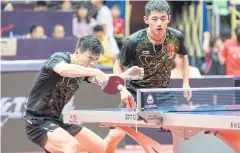  ??  ?? Ma Long and Zhang Jike compete in a doubles match at the China Open table-tennis tournament in June. Ma Long boycotted his second-round match in a protest against the sudden removal of national team coach Liu Guoliang.