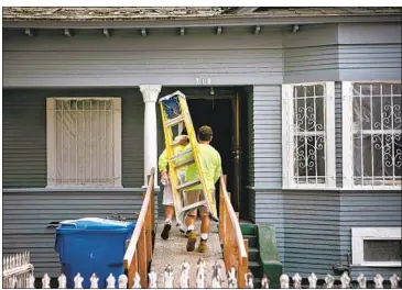  ?? Jason Armond Los Angeles Times ?? WORKERS ENTER a South Los Angeles home Thursday to repair damage from a June 30 fireworks blast. It remains unclear how much taxpayers will owe for the explosion, an LAPD mistake that left 17 people injured.