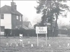  ?? ?? From left, John Philpott and Alan Huggett with the sign about new rules in Lenham on April Fools’ Day 2005; the sign in Sandhurst suggesting KCC was to build a mosque; and the wild boar which “found a grenade”