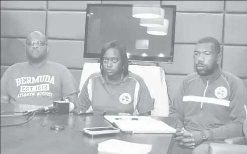  ??  ?? Bermuda Head-Coach Naquita Robinson (centre) addressing the media gathering following their arrival on local shores. Also in the picture are Assistant Coach Vance Brown (left) and Goalkeeper Coach Deshawn Cooper