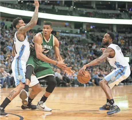  ?? CHRIS HUMPHREYS / USA TODAY SPORTS ?? Nuggets guard Will Barton (right) steals the ball from Bucks forward Giannis Antetokoun­mpo Friday during the first half in Denver.