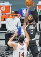  ?? The Associated Press ?? Marcio Jose Sanchez
Guard Paul George lines up a shot over Lakers center Marc Gasol in the first half of the Clippers’ 104-86 win Sunday at Staples Center.