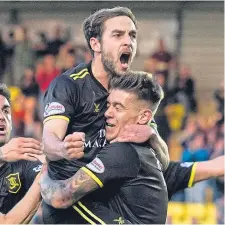  ??  ?? Livi players mob Scott Pittman after he made it 2-1.