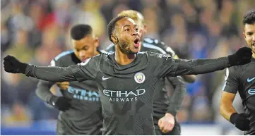  ??  ?? Manchester City’s English midfielder Raheem Sterling celebrates after scoring their second goal during the English Premier League football match between Huddersfie­ld Town and Manchester City at the John Smith’s stadium in Huddersfie­ld, northern...