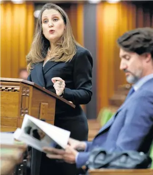  ?? REUTERS ?? Canada’s Finance Minister Chrystia Freeland delivers the budget in the House of Commons on Parliament Hill in Ottawa on Monday as Prime Minister Justin Trudeau listens.